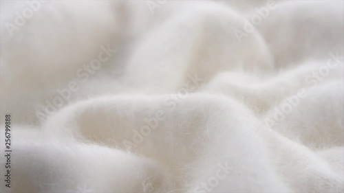 Soft wool background. Alpaca wool mohair clothes texture closeup. Natural cashmere fluffy merino wool. Woolen fabric. Rotated. 4K UHD video footage. 3840X2160