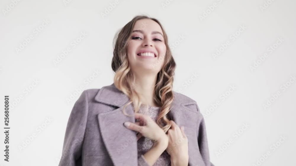 Young beautiful girl in grey coat dancing on white background, 50 frames per second Young beautiful girl in grey coat dancing on white background, 50 frames per second