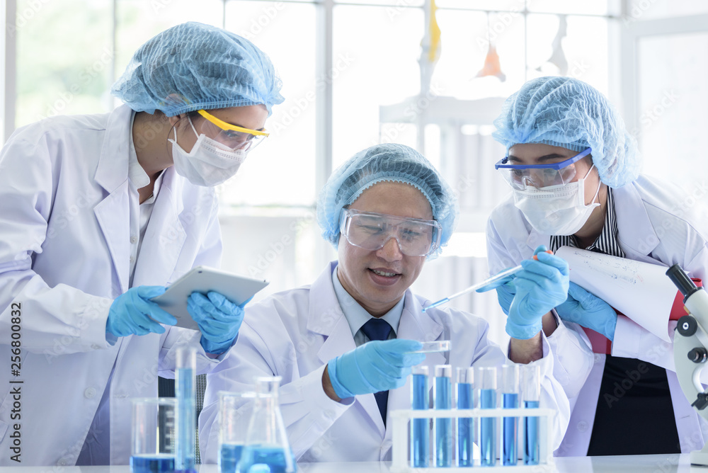 Asian scientist team has researching in laboratory. Asian scientist team has researching in laboratory.