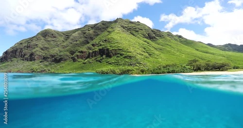 Under and Above Clear, Blue Water and Green Mountains on Oahu Hawaii photo
