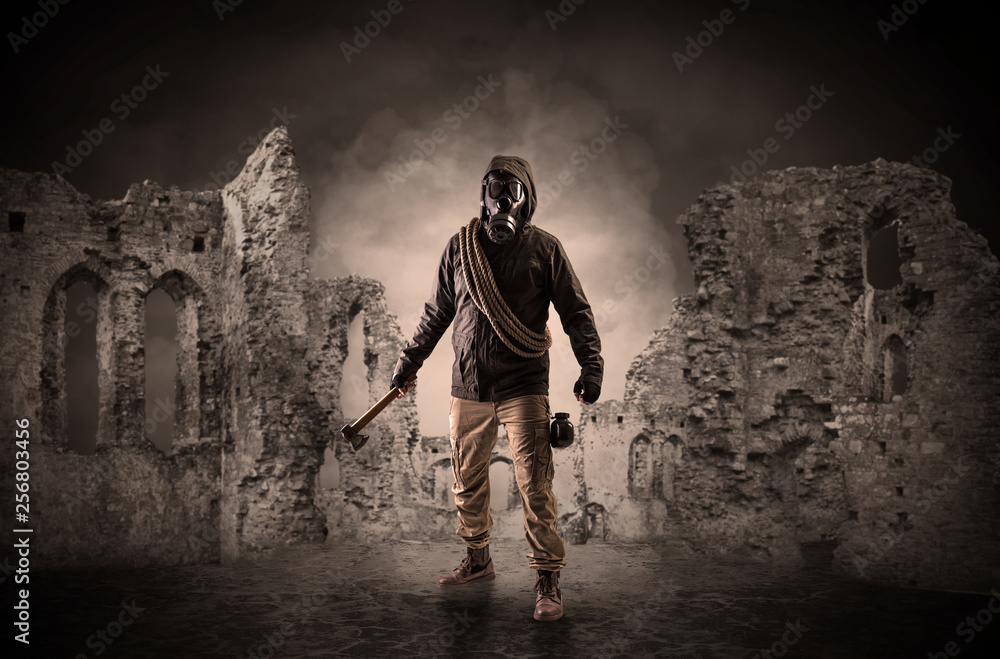 Fototapeta premium Hazard, menace man in a ruined crumbly building with arms on his hand 