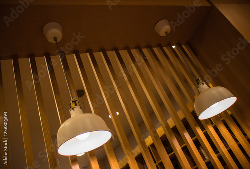 Lighting fixture lamps are hanging on textile classic cable from the ceiling photo