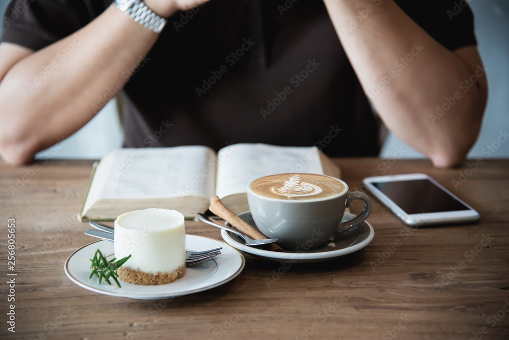 Relax Asian man drink coffee and read book in a modern style coffee shop - people with coffee cup easy lifestyle concept Relax Asian man drink coffee and read book in a modern style coffee shop - people with coffee cup easy lifestyle concept