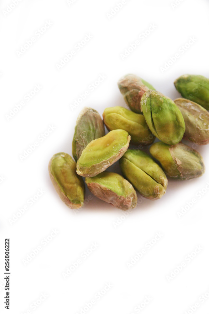 Shelled pistachios isolated on white background in selective focus Shelled pistachios isolated on white background in selective focus