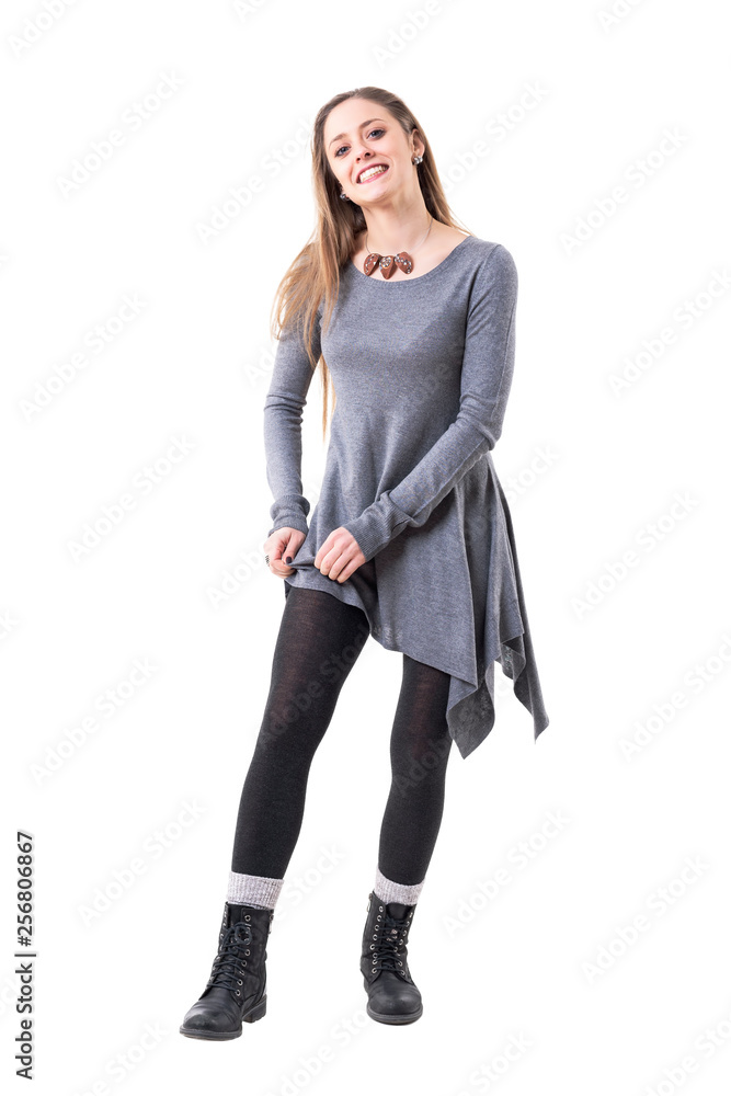Playful young happy stylish woman getting dressed pulling up tights. Full  body isolated on white background. Stock Photo