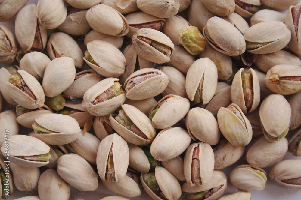 Pistachios background in selective focus. Nuts background Pistachios background in selective focus. Nuts background