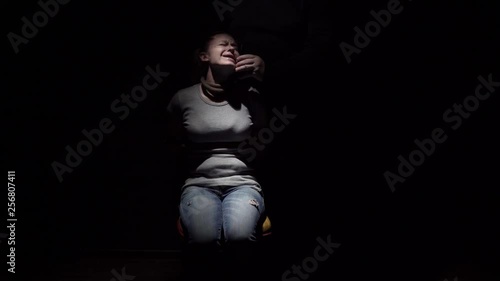 Kidnapper threatens girl with knife and calls on phone demanding money. Close-up.