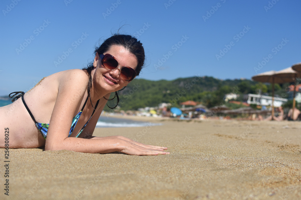 Woman lies and enjoy at beach. Summer vacations concept, sexy woman on tropical beach Woman lies and enjoy at beach. Summer vacations concept, sexy woman on tropical beach