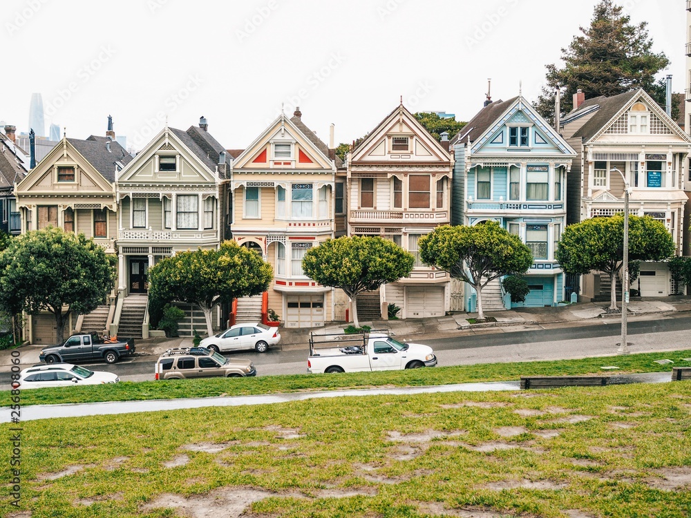 Victorian multicolored houses in San Francisco, street on a cloudy day, beautiful stairs