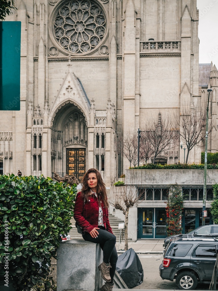 Girl with long hair sitting near grace Cathedral in San Francisco