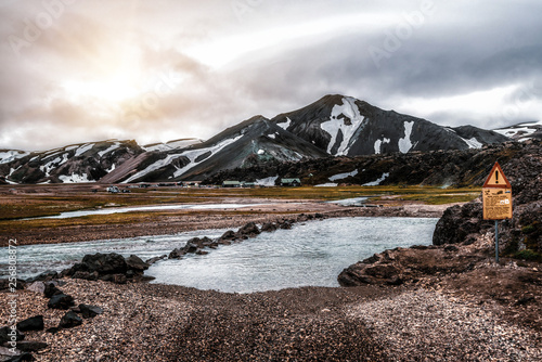 Beautiful Landmanalaugar gravel dust road way on highland of Iceland, Europe. Muddy tough terrain for extreme 4WD 4x4 vehicle. Landmanalaugar landscape is famous for nature trekking and hiking. photo