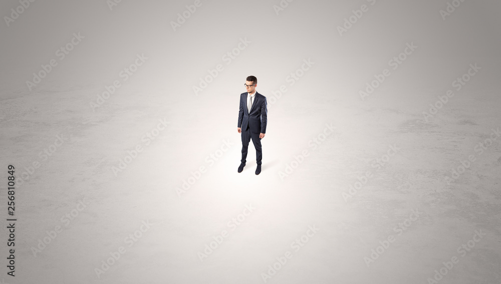 Young businessman standing alone in the middle of an empty space
Young businessman standing alone in the middle of an empty space