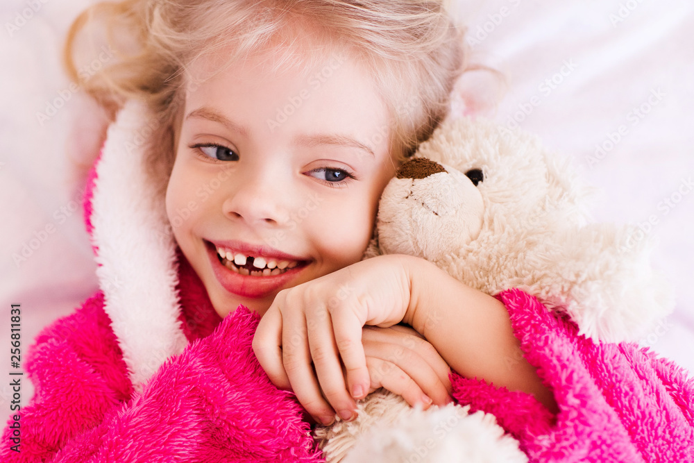 Happy baby girl 3-4 year old smiling with teddy brea in bed. Friendship. Childhood. Happy baby girl 3-4 year old smiling with teddy brea in bed. Friendship. Childhood.