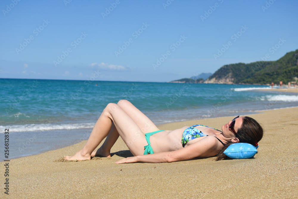 Woman lies and enjoy at beach. Summer vacations concept, sexy woman on tropical beach