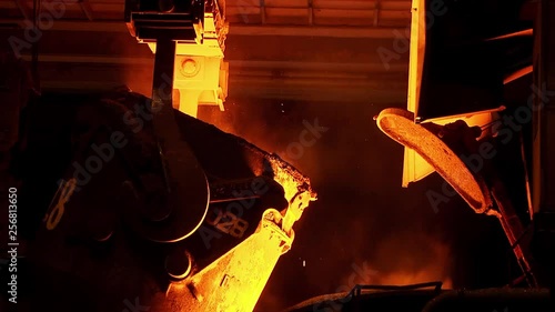 The process of pouring iron into the converter. Steel production at a metallurgical plant.