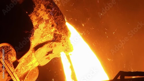 The process of pouring iron into the converter. Steel production at a metallurgical plant.