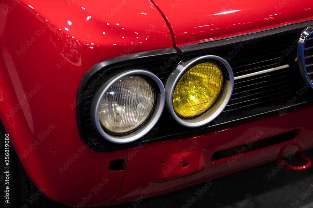 A close up of a classic vintage car headlight