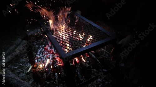 Camp dinner. Preparing food on a camp fire.