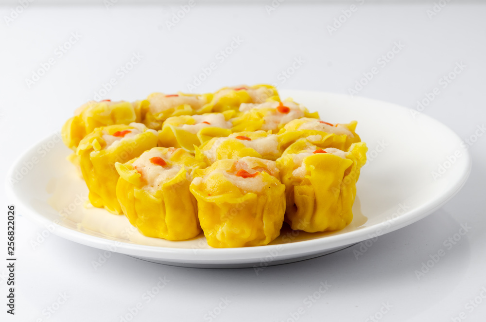 Chinese steamed shrimp dumplings on white dish