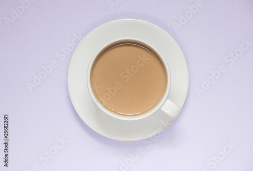 Cup of coffee with milk on a colored background  top view