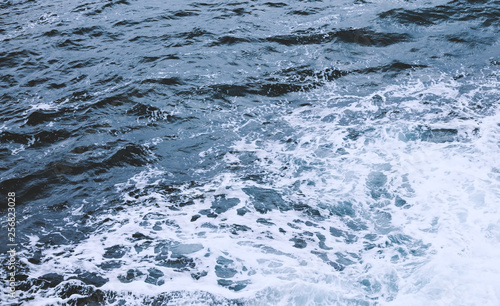 Blue rippled water as abstract background. Tranquil surface texture of the sea.