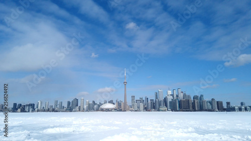 View of Toronto city skyline form Toronto Islands across frozen lake Ontario