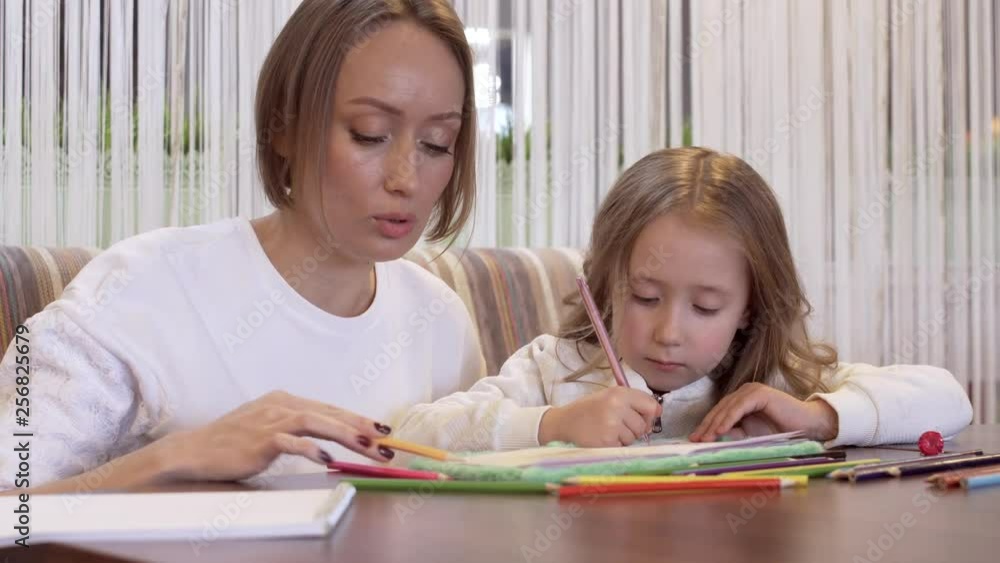 Beautiful Young Woman Mother Draws With Her Cute Little Daughter Beautiful Young Woman Mother Draws With Her Cute Little Daughter