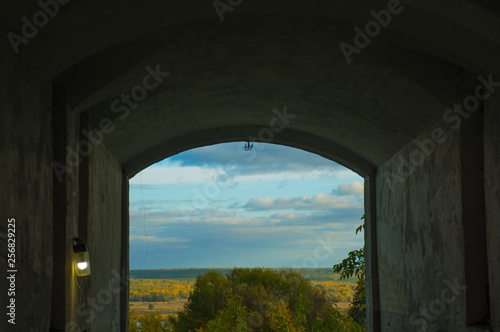 arch of an old house on the background of a Sunny landscape