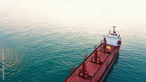 Large high-speed sea vessel for transporting a dry-cargo ship at high speed leaves the city sea port to open blue sea space. Import and export of goods by sea. Copyspace