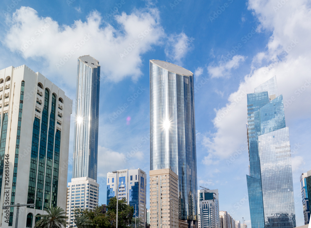 Modern city architecture and famous skyscrapers of Abu Dhabi skyline with beautiful clouds, World Trade Center UAE Modern city architecture and famous skyscrapers of Abu Dhabi skyline with beautiful clouds, World Trade Center UAE