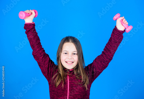 training of small girl hold dumbbell. Happy child training with barbell. happy training. Fitness diet for energy. weight lifting for muscules. Childhood activity. Sport success. training fitness photo