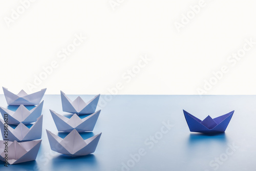Fototapeta Naklejka Na Ścianę i Meble -  Paper boats on light blue surface on white background
