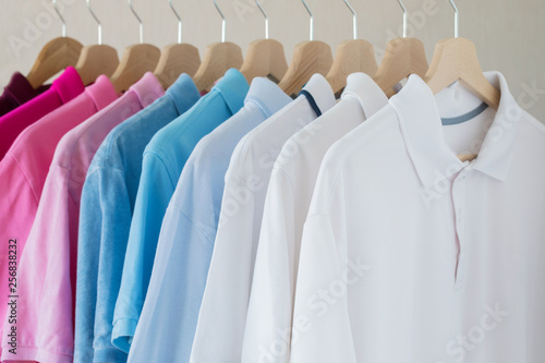 Man's shirts hanging on rack in row
