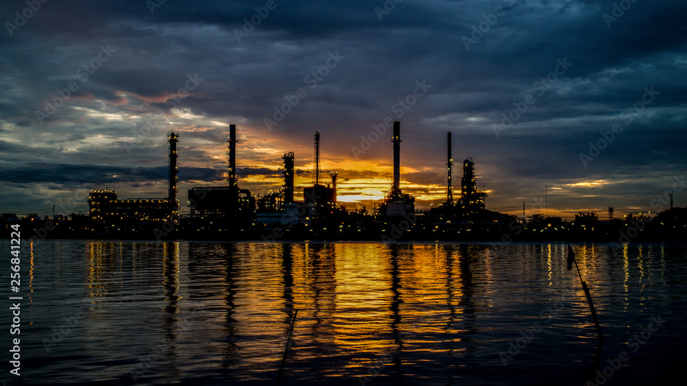 The silhouette of a refinery In Sunrise