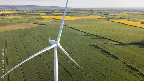 Obraz na płótnie photos of wind turbines providing renewable green energy in england in the country side w salonie