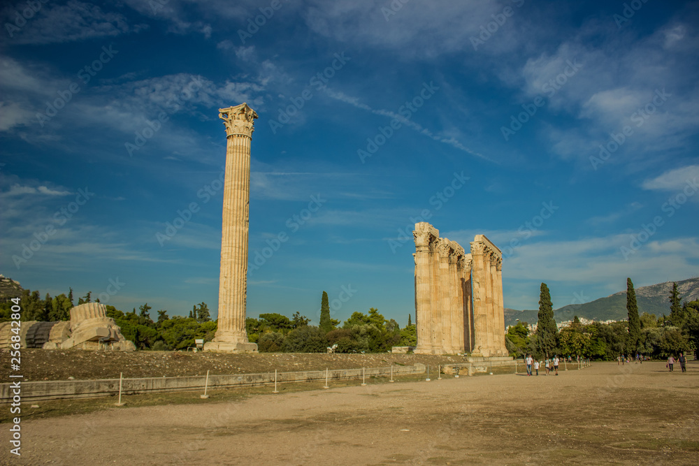 tourism and sightseeing concept of destroyed marble pillars building of ruined temple from ancient Greece times in park outdoor natural environment 