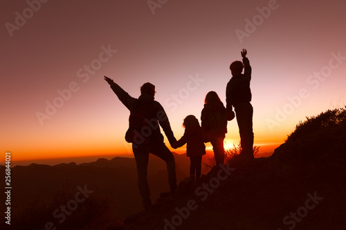 happy father with kids travel in sunset mountains