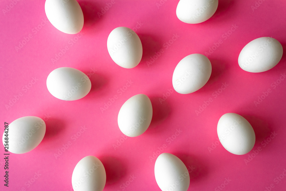 Pattern made of white eggs on bright pink color background Pattern made of white eggs on bright pink color background