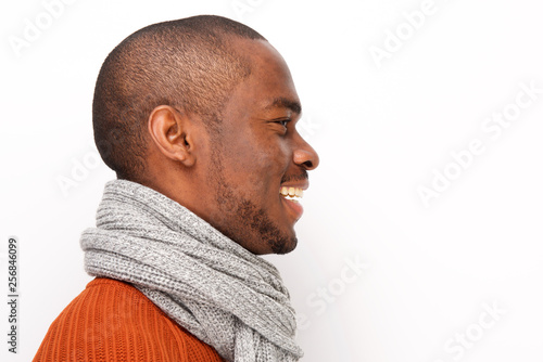 Profile of smiling black man with scarf against white background