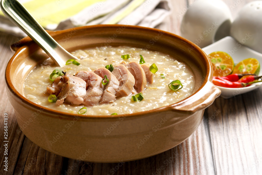 Delicious Chicken Rice Porridge on the table. Filipino cuisine. Arroz caldo. Delicious Chicken Rice Porridge on the table. Filipino cuisine. Arroz caldo.