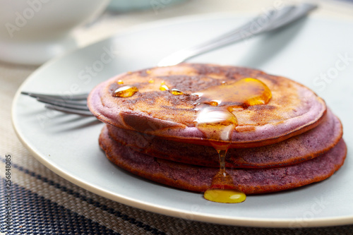 Delicious dessert. Pancakes with purple jam. Ube Pancakes.