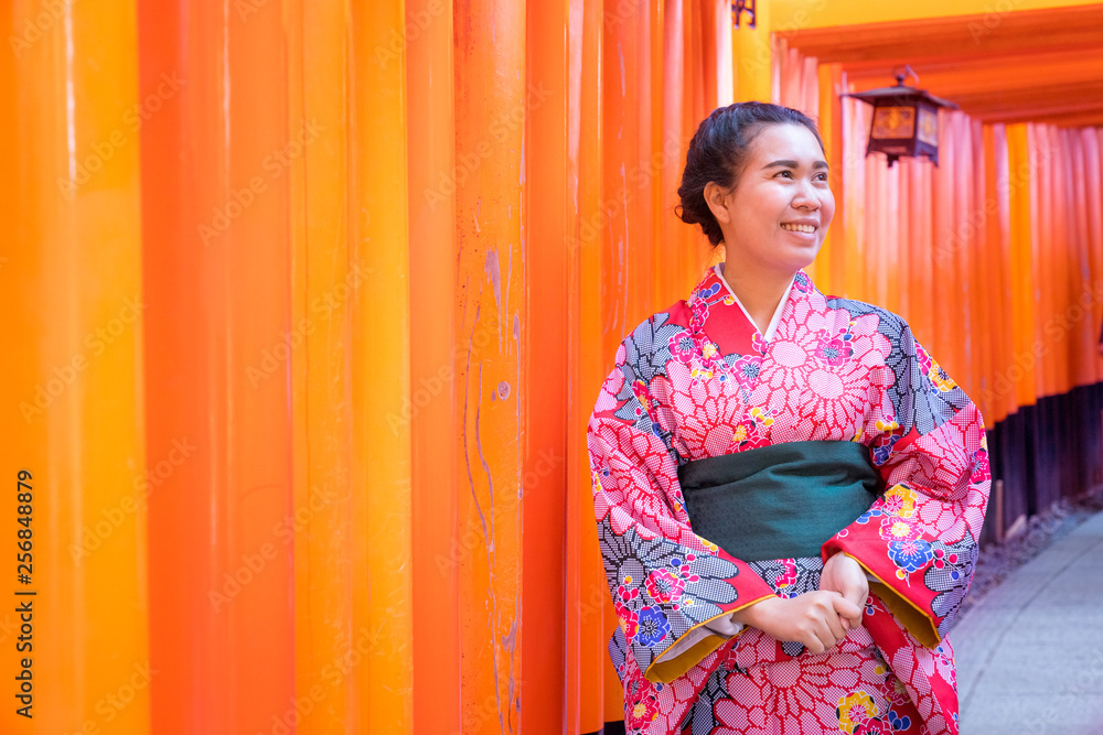 Asia women in traditional japanese kimonos happy and smiling at Fushimi Inari Shrine in Kyoto, Japan.