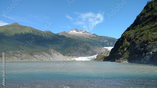 Mendenhall Glacier Juneau Alaska. Mendenhall Glacier flowing into Mendenhall Lake in between mountains with Nugget falls. Perfect tourist location © Justin