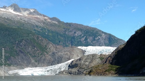 Mendenhall Glacier Juneau Alaska. Mendenhall Glacier flowing into Mendenhall Lake in between mountains with Nugget falls. Perfect tourist location © Justin