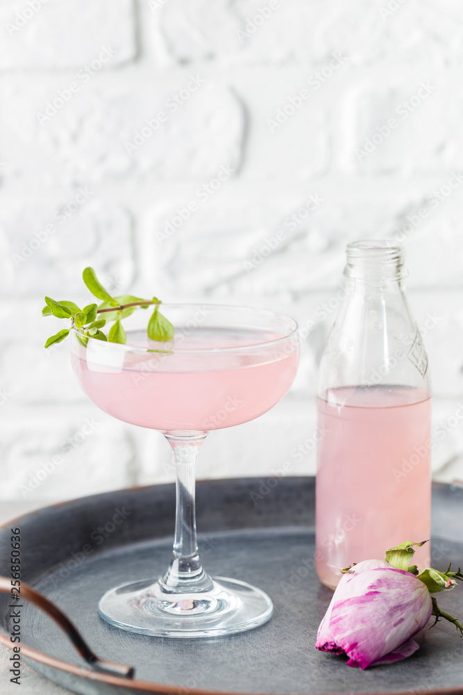 Summer refreshment drinks. Light pink rose cocktail, with rose wine on a white table. With rose flowers. Copy space Summer refreshment drinks. Light pink rose cocktail, with rose wine on a white table. With rose flowers. Copy space