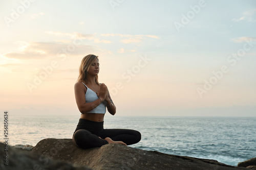 Woman Practicing Yoga in the Nature. Meditating Outdoors