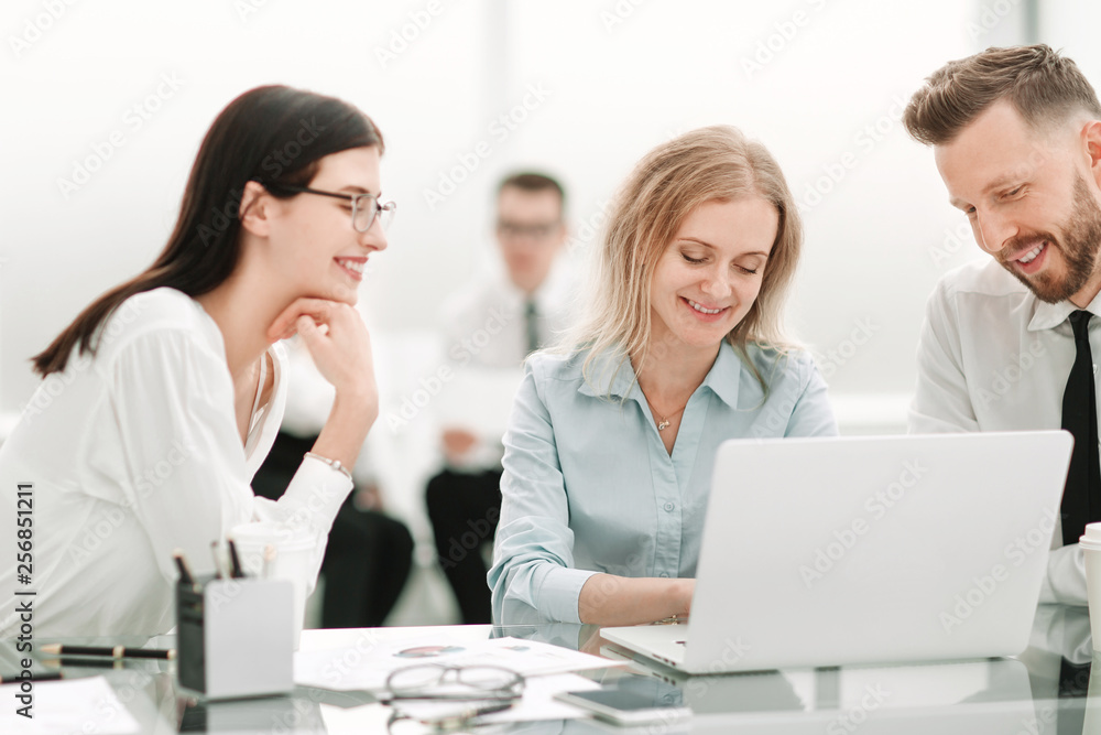 smiling employees sitting at the office Desk smiling employees sitting at the office Desk