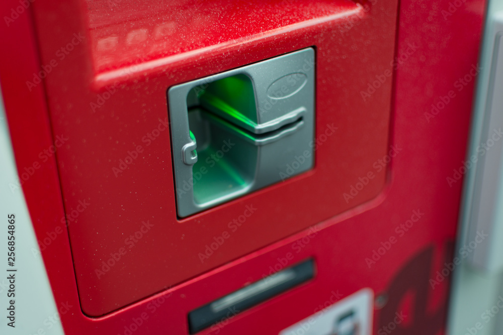 close up of red atm machine insert card here close up of red atm machine insert card here