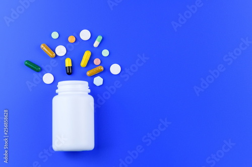 Medicine tablet, pill, capsule on medical blue background