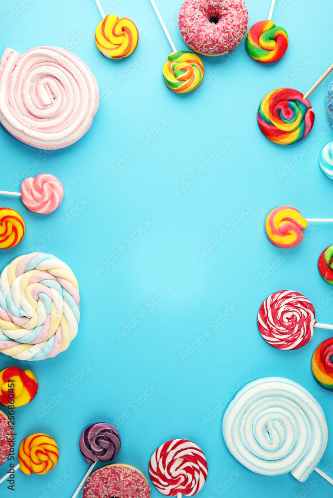candies with jelly and sugar. colorful array of different childs sweets and treats on blue candies with jelly and sugar. colorful array of different childs sweets and treats on blue